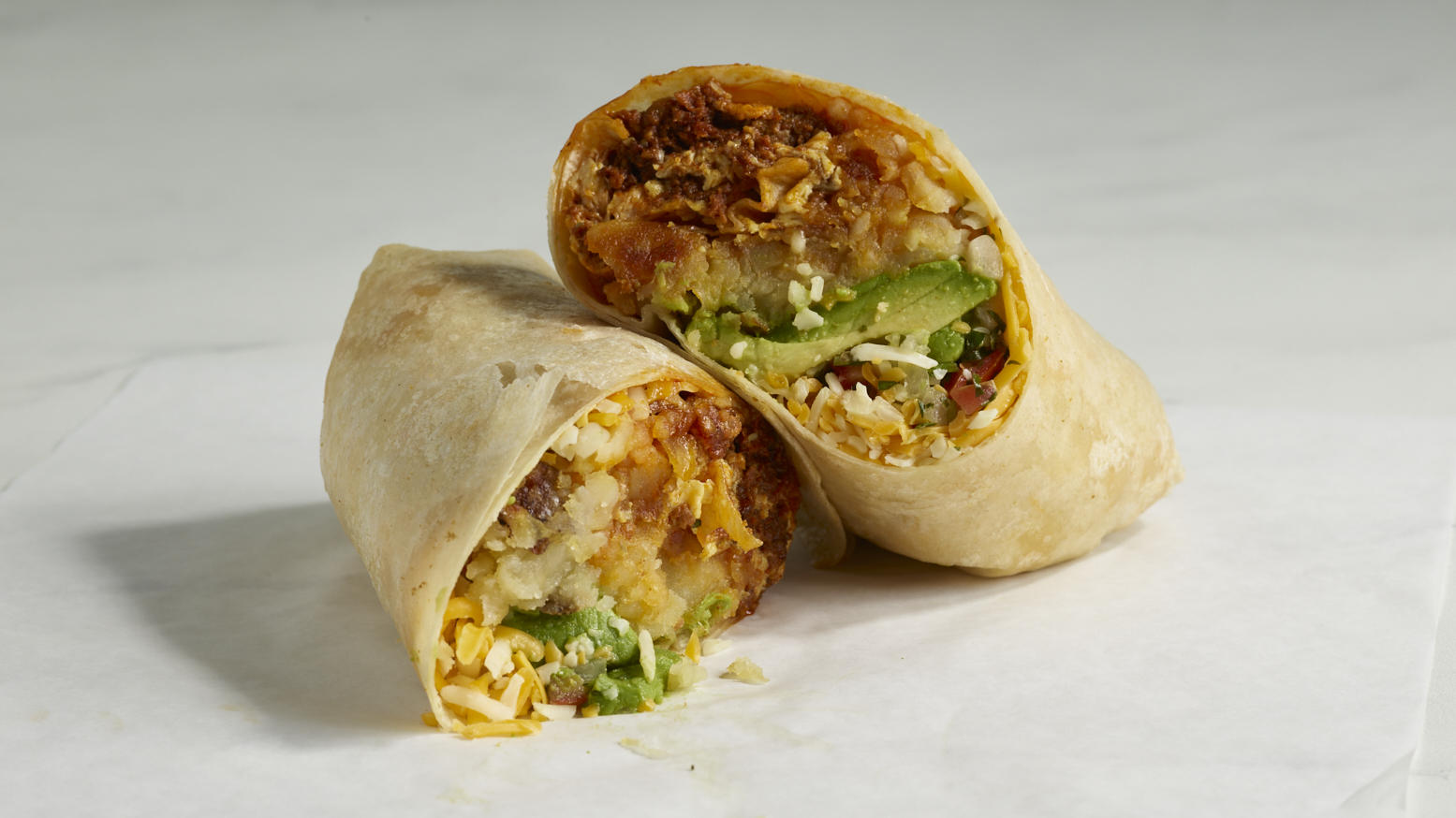 Chorizo Breakfast Burrito with potatoes, cheese, avocado and salsa
