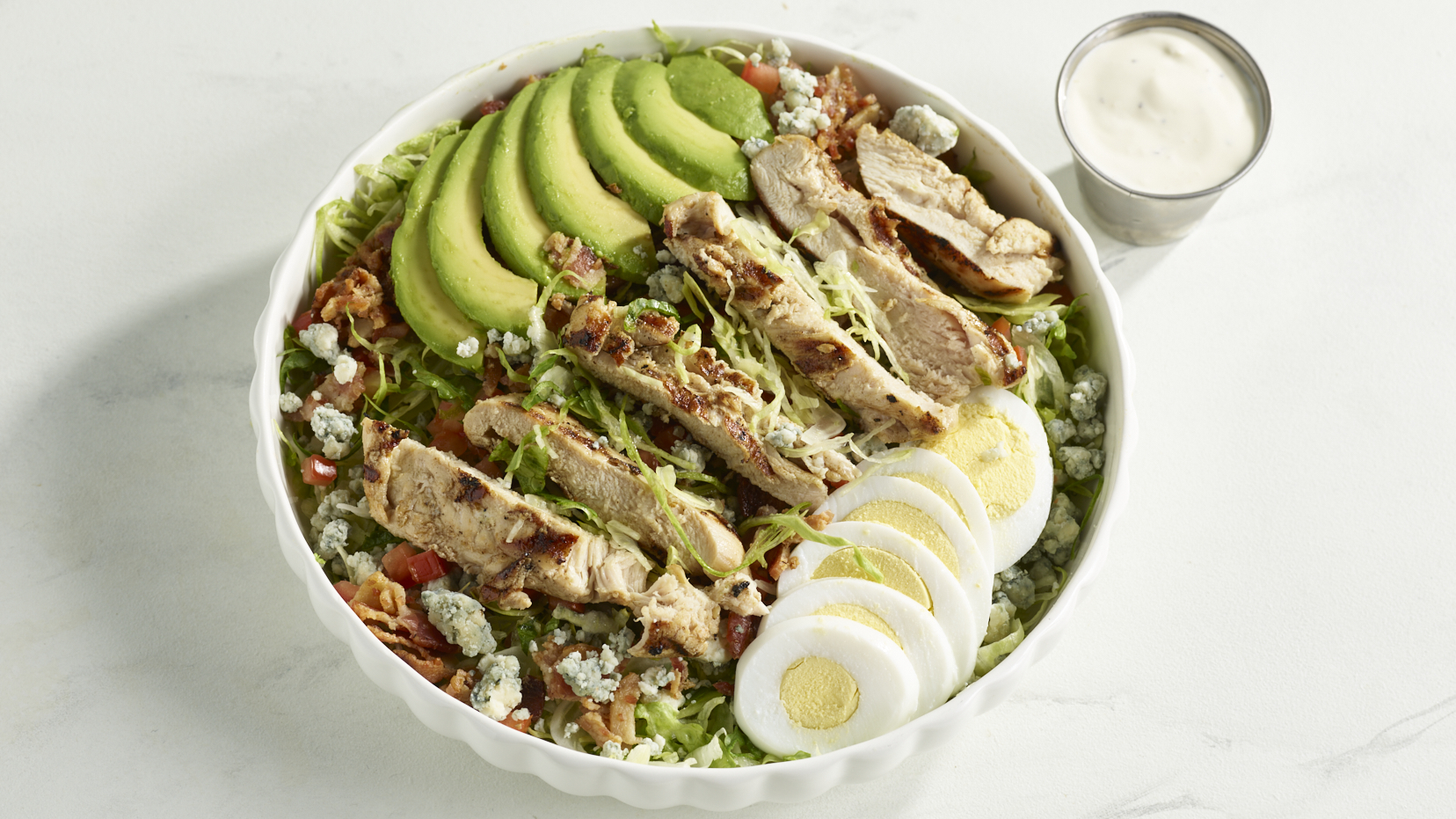 Cobb Salad with grilled chicken, avocado, bacon, egg, blue cheese and tomatoes